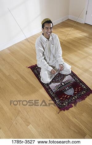 Portrait of a Muslim man praying on a prayer mat View Large Photo Image Stock Photo - Portrait of a Muslim man praying on a prayer mat. Fotosearch
