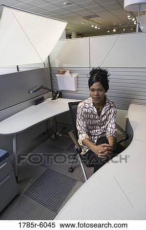 Portrait of a pensive young woman sitting in a new office cubicle View Large Photo Image Stock Photography - Portrait of a pensive young woman sitting in a new office cubicle. Fotosearch