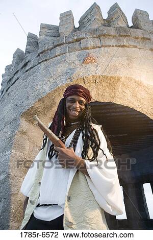 Portrait of a pirate armed with a gun standing outside a castle turret View Large Photo Image Stock Image - Portrait of a pirate armed with a gun standing outside a castle turret. Fotosearch