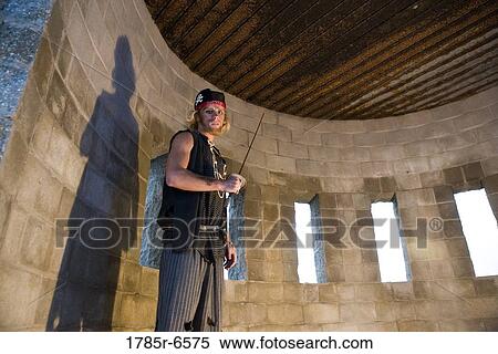 Portrait of a pirate armed with a sword inside a castle turret View Large Photo Image Stock Photography - Portrait of a pirate armed with a sword inside a castle turret. Fotosearch