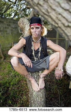 Portrait of a pirate sitting on a tree trunk View Large Photo Image Stock Image - Portrait of a pirate sitting on a tree trunk. Fotosearch