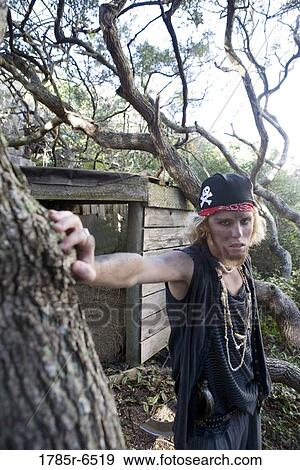 Portrait of a pirate standing near trees View Large Photo Image Stock Photo - Portrait of a pirate standing near trees. Fotosearch