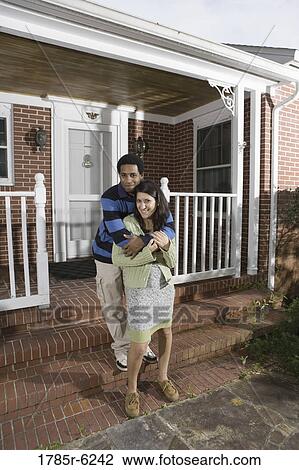 Portrait of a smiling young interracial couple on front steps house View Large Photo Image Stock Image - Portrait of a smiling young interracial couple on front steps house. Fotosearch