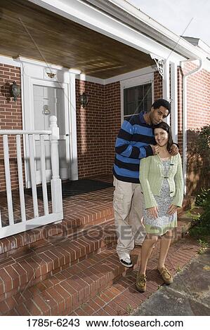 Portrait of a smiling young interracial couple on front steps house View Large Photo Image Stock Image - Portrait of a smiling young interracial couple on front steps house. Fotosearch