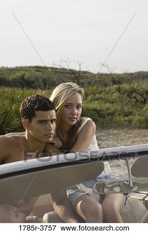 Portrait of a young couple sitting in antique convertible car View Large Photo Image Stock Photo - Portrait of a young couple sitting in antique convertible car. Fotosearch