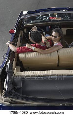 Portrait of a young hip-hop couple sitting in a pimped-up vintage car View Large Photo Image Stock Image - Portrait of a young hip-hop couple sitting in a pimped-up vintage car. Fotosearch
