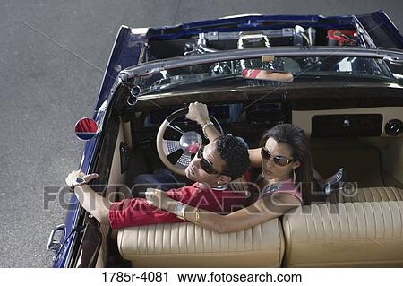 Portrait of a young hip-hop couple sitting in a pimped-up vintage car View Large Photo Image Stock Image - Portrait of a young hip-hop couple sitting in a pimped-up vintage car. Fotosearch