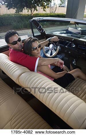 Portrait of a young hip-hop couple sitting in a pimped-up vintage car View Large Photo Image Stock Image - Portrait of a young hip-hop couple sitting in a pimped-up vintage car. Fotosearch