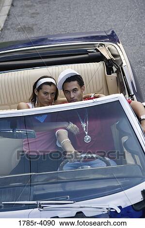 Portrait of a young hip-hop couple sitting in a pimped-up vintage car View Large Photo Image Stock Image - Portrait of a young hip-hop couple sitting in a pimped-up vintage car. Fotosearch