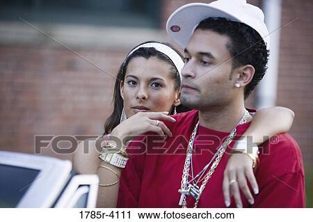 Portrait of a young hip-hop couple sitting in a pimped-up vintage car View Large Photo Image Stock Image - Portrait of a young hip-hop couple sitting in a pimped-up vintage car. Fotosearch