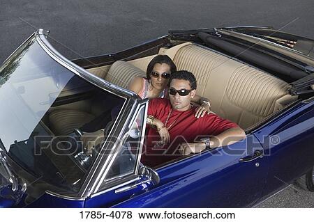 Portrait of a young hip-hop couple sitting in a pimped-up vintage car View Large Photo Image Stock Photo - Portrait of a young hip-hop couple sitting in a pimped-up vintage car. Fotosearch