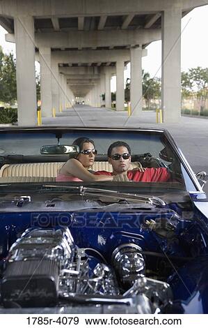 Portrait of a young hip-hop couple sitting in a pimped-up vintage car View Large Photo Image Stock Photo - Portrait of a young hip-hop couple sitting in a pimped-up vintage car. Fotosearch
