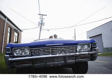 Portrait of a young hip-hop couple sitting in a pimped-up vintage car in depressed urban neighborhood View Large Photo Image Stock Photograph - Portrait of a young hip-hop couple sitting in a pimped-up vintage car in depressed urban neighborhood. Fotosearch