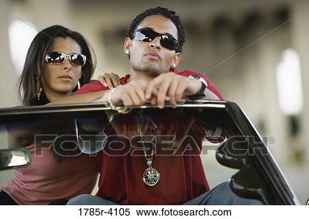 Portrait of a young hip-hop couple sitting in a convertible View Large Photo Image Stock Photography - Portrait of a young hip-hop couple sitting in a convertible. Fotosearch