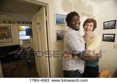 Portrait of a young inter-racial couple hugging View Large Photo Image Stock Image - Portrait of a young inter-racial couple hugging. Fotosearch