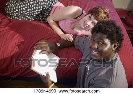 Portrait of a young inter-racial couple in a bedroom View Large Photo Image Stock Image - Portrait of a young inter-racial couple in a bedroom. Fotosearch