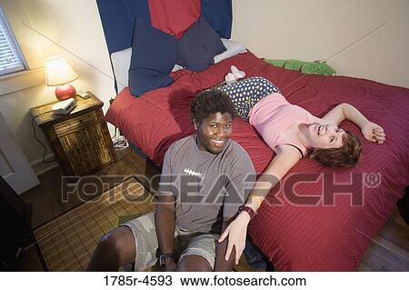 Portrait of a young inter-racial couple smiling View Large Photo Image Stock Image - Portrait of a young inter-racial couple smiling. Fotosearch
