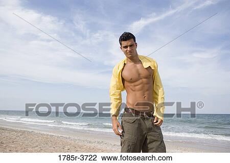 Portrait of a young man with open shirt at the beach View Large Photo Image Stock Image - Portrait of a young man with open shirt at the beach. Fotosearch