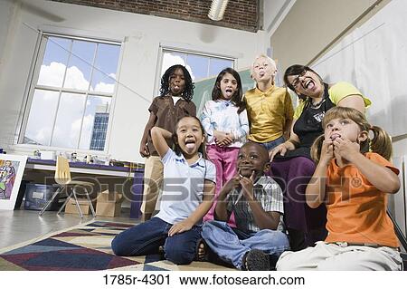 Portrait of an art teacher posing with her students making funny faces View Large Photo Image Stock Image - Portrait of an art teacher posing with her students making funny faces. Fotosearch