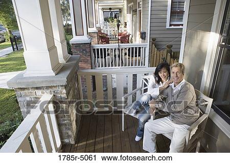 Portrait of an inter-racial couple sitting on the front porch View Large Photo Image Stock Image - Portrait of an inter-racial couple sitting on the front porch. Fotosearch