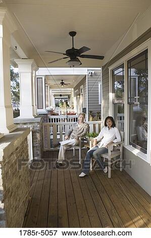 Portrait of an inter-racial couple sitting on the front porch View Large Photo Image Stock Photo - Portrait of an inter-racial couple sitting on the front porch. Fotosearch