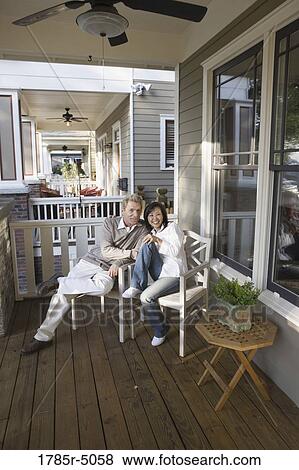 Portrait of an inter-racial couple sitting on the front porch View Large Photo Image Stock Photo - Portrait of an inter-racial couple sitting on the front porch. Fotosearch