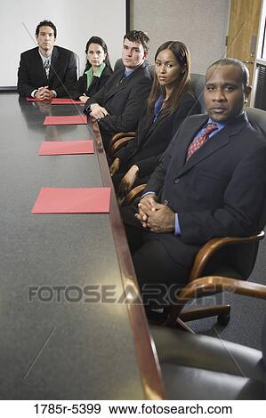 Portrait of business executives sitting abreast in a formal conference room View Large Photo Image Stock Photo - Portrait of business executives sitting abreast in a formal conference room. Fotosearch