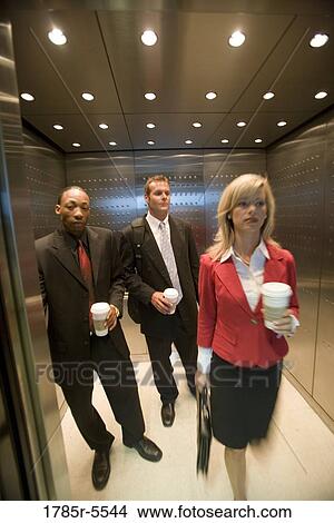 Portrait of business people riding in an elevator View Large Photo Image Picture - Portrait of business people riding in an elevator. Fotosearch