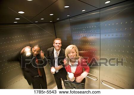 Portrait of business people riding in an elevator View Large Photo Image Stock Image - Portrait of business people riding in an elevator. Fotosearch