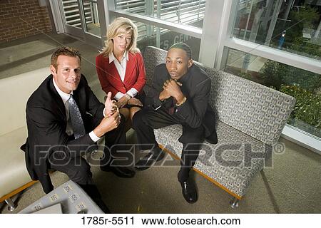 Portrait of business people sitting in an office lobby View Large Photo Image Stock Image - Portrait of business people sitting in an office lobby. Fotosearch