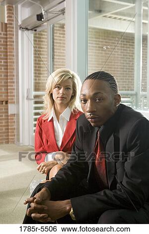 Stock Photograph - Portrait of business people sitting in an office lobby. Fotosearch