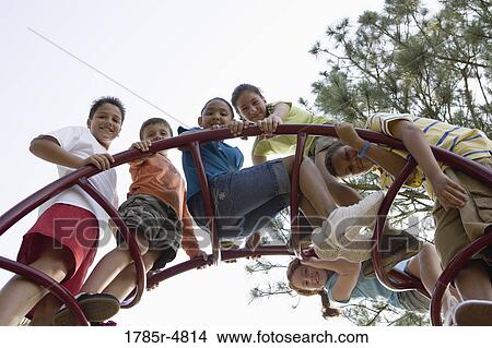 Portrait of children climbing on monkey bars at a playground View Large Photo Image Picture - Portrait of children climbing on monkey bars at a playground. Fotosearch