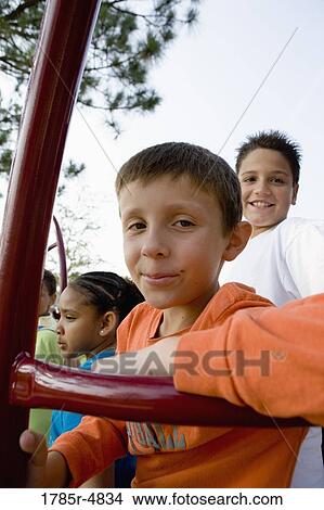 Portrait of children climbing on monkey bars at a playground View Large Photo Image Picture - Portrait of children climbing on monkey bars at a playground. Fotosearch