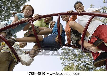 Portrait of children climbing on monkey bars at a playground View Large Photo Image Stock Image - Portrait of children climbing on monkey bars at a playground. Fotosearch