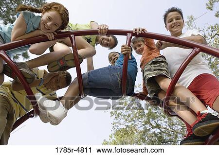 Portrait of children climbing on monkey bars at a playground View Large Photo Image Stock Image - Portrait of children climbing on monkey bars at a playground. Fotosearch