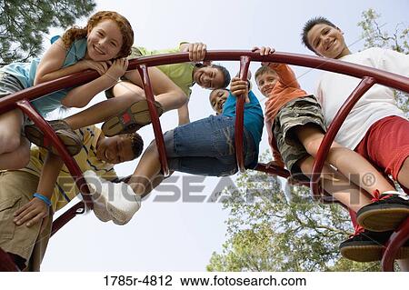 Portrait of children climbing on monkey bars at a playground View Large Photo Image Stock Image - Portrait of children climbing on monkey bars at a playground. Fotosearch
