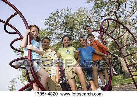 Portrait of children climbing on monkey bars at a playground View Large Photo Image Stock Image - Portrait of children climbing on monkey bars at a playground. Fotosearch