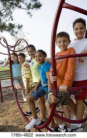 Portrait of children climbing on monkey bars at a playground View Large Photo Image Stock Image - Portrait of children climbing on monkey bars at a playground. Fotosearch