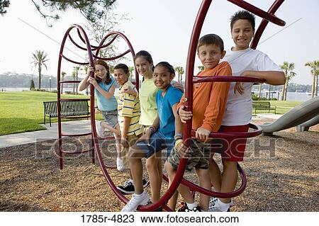 Portrait of children climbing on monkey bars at a playground View Large Photo Image Stock Image - Portrait of children climbing on monkey bars at a playground. Fotosearch
