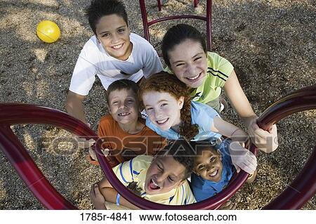 Portrait of children climbing on monkey bars at a playground View Large Photo Image Stock Image - Portrait of children climbing on monkey bars at a playground. Fotosearch