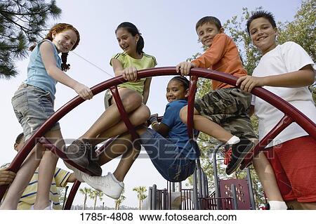 Portrait of children climbing on monkey bars at a playground View Large Photo Image Stock Photo - Portrait of children climbing on monkey bars at a playground. Fotosearch