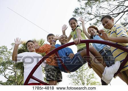 Portrait of children climbing on monkey bars at a playground View Large Photo Image Stock Photo - Portrait of children climbing on monkey bars at a playground. Fotosearch