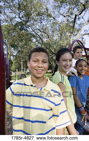 Portrait of children climbing on monkey bars at a playground View Large Photo Image Stock Photo - Portrait of children climbing on monkey bars at a playground. Fotosearch