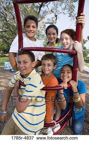 Portrait of children climbing on monkey bars at a playground View Large Photo Image Stock Photo - Portrait of children climbing on monkey bars at a playground. Fotosearch