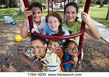 Portrait of children climbing on monkey bars at a playground View Large Photo Image Stock Photo - Portrait of children climbing on monkey bars at a playground. Fotosearch