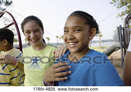 Portrait of children climbing on monkey bars at a playground View Large Photo Image Stock Photography - Portrait of children climbing on monkey bars at a playground. Fotosearch