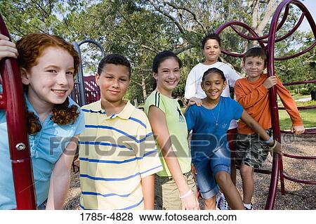 Portrait of children on monkey bars at a playground View Large Photo Image Stock Photo - Portrait of children on monkey bars at a playground. Fotosearch