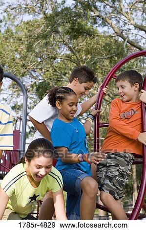 Portrait of children on monkey bars at a playground View Large Photo Image Stock Photo - Portrait of children on monkey bars at a playground. Fotosearch