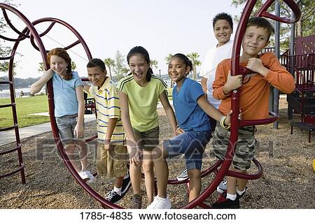Portrait of children on monkey bars at a playground View Large Photo Image Stock Photography - Portrait of children on monkey bars at a playground. Fotosearch