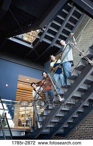 Portrait of college students standing on staircase View Large Photo Image Stock Image - Portrait of college students standing on staircase. Fotosearch
